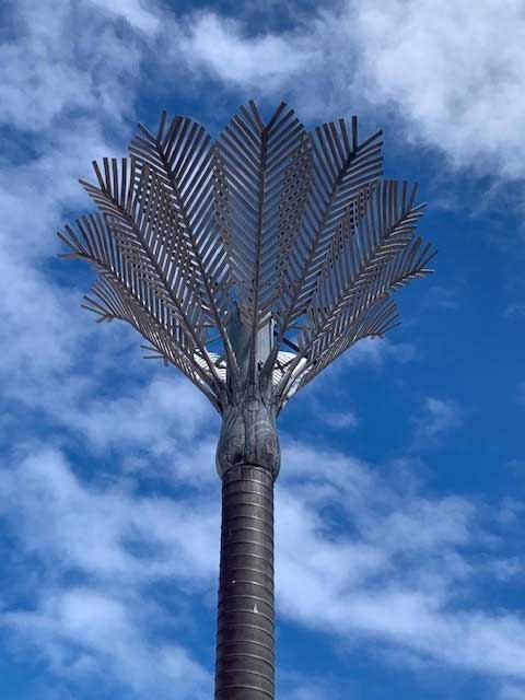 The silver nikau palm sculpture in Wellington against a blue sky